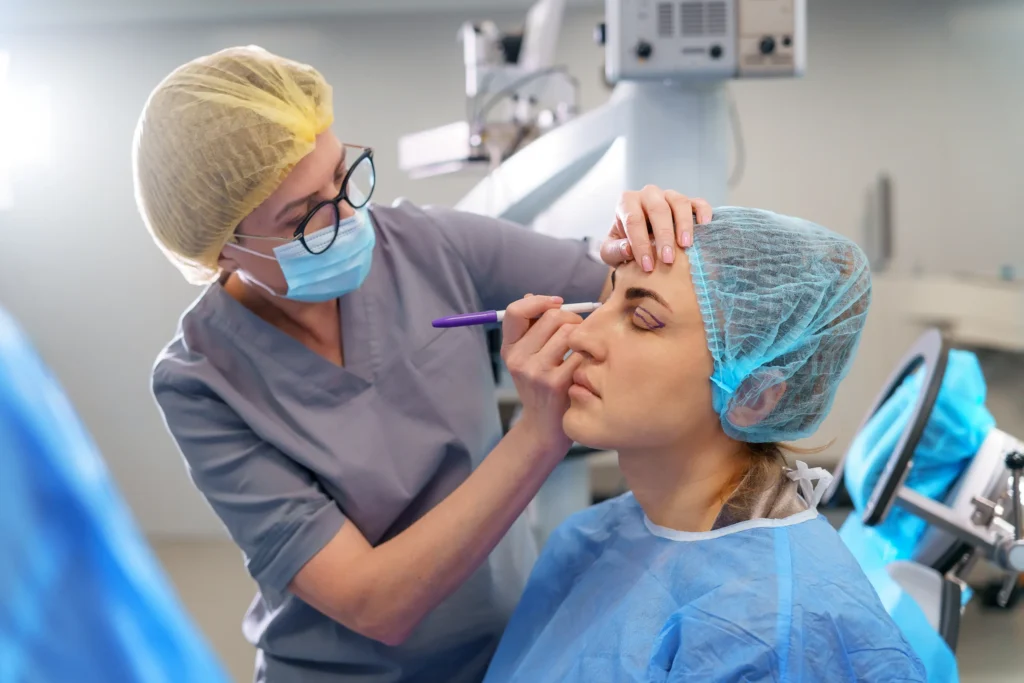 Surgeon marking the eyelid of a patient before facial surgery
